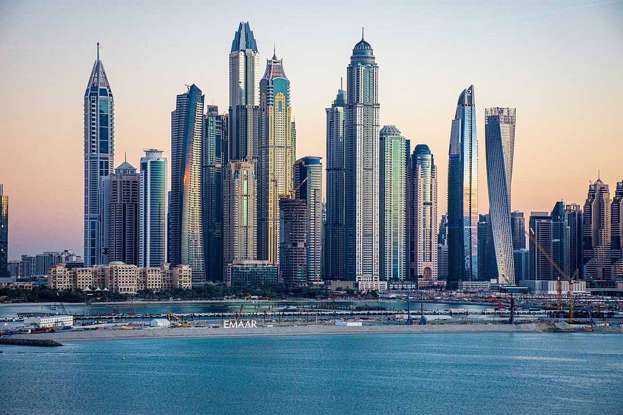 High-rise towers of Dubai Marina at dusk seen across the water